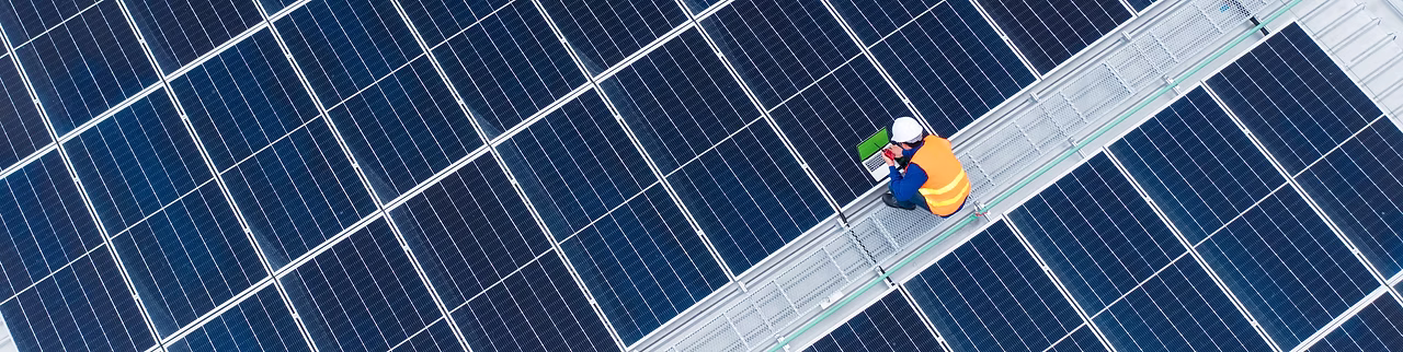 A staff checking solar panels